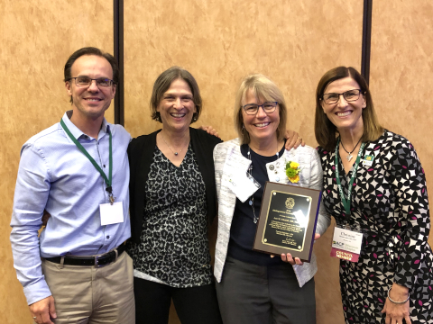 Mark Micek, MD, MPH, clinical associate professor, General Internal Medicine (left), and Elizabeth Trowbridge, MD, Phillip August and Sarah Neely Herrmann Professor in General Internal Medicine and interim chair, Department of Medicine (second from left), join Drs. Schmidt and Seibert in celebrating Dr. Schmidt’s award.