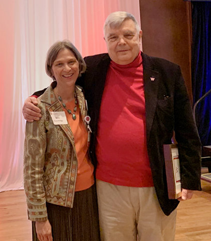 Dr. Betsy Trowbridge congratulates Dr. Dennis Maki after he receives the WAA Distinguished Alumni Award