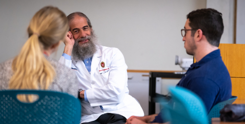 Dr. Vogelman talks with internal medicine residents during a 2018 Morning Report. 