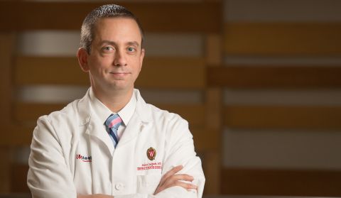 Dr. Alex Lepak in white coat