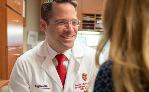 Dr. Andrew Braun talks in the office