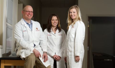 Three infectious disease physicians with white coats