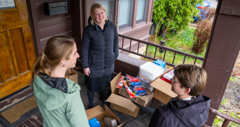 Hannah Bell talks with Kirsten Alman and Christina Hughey after delivering medical supplies to the Healing House