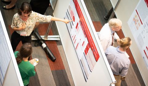 birds-eye view of people looking at posters on Research Day 2019