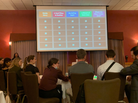 Conference attendees play jeopardy.