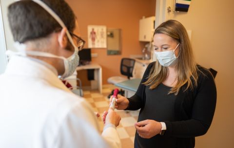 Pharmacist Shelby Gomez show a rheumatology faculty member how to teach patients to give self-injections