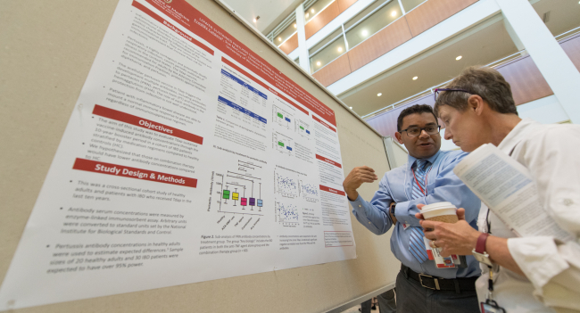 Dr. Freddy Caldera discusses his poster at Research Day
