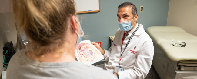 Dr. Parajuli in clinic with a patient.