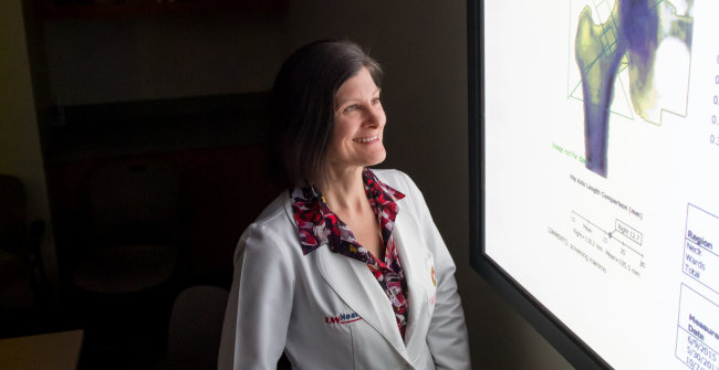 photo of Dr. Karen Hansen looking at bone density scan