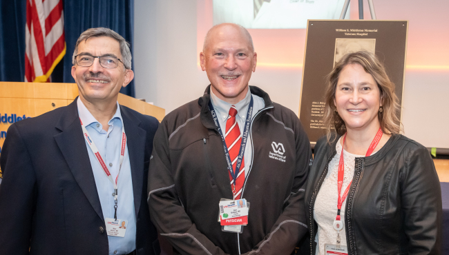 Dr. Alan Bridges poses between longtime Department of Medicine colleagues, Rheumatology chief Nizar Jarjour, MD, on the left, and department administrator, Sheri Lawrence, MBA, on the right.