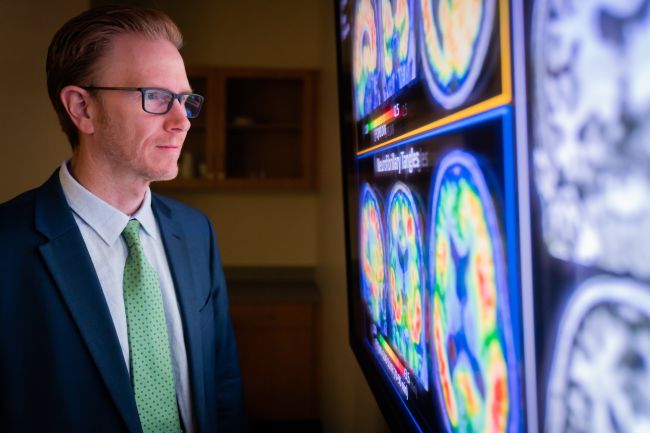 Sterling Johnson, PhD, professor, Geriatrics and Gerontology, views brain imaging results.