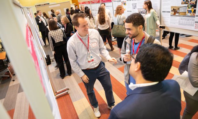 Residency program director Andy Coyle, MD, center, with a trainee (center-right) and Fahad Aziz, MD (foreground).