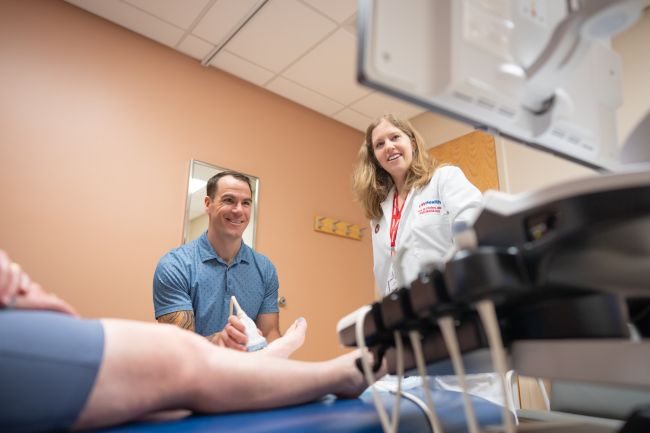 Above, Dr. Brian Kroll performs an ultrasound-guided examination with guidance from Rheumatology faculty member Dr. Ann Chodara.