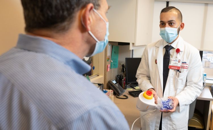 Allergy and Immunology fellow talking with faculty member in clinic