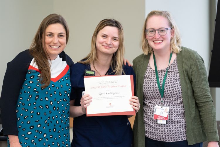 Dr. Sylwia Kaeding holds WILD program completion certificate, Dr. Sarah Donohue and Dr. Dana Ley stand on either side of her