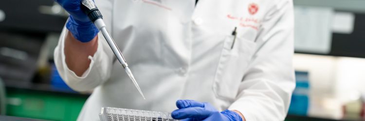 Closeup photo of Dr. Miriam Shelef using a pipette