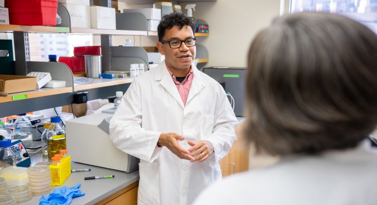 Dr. Caldera talking to Dr. Hayney in the lab