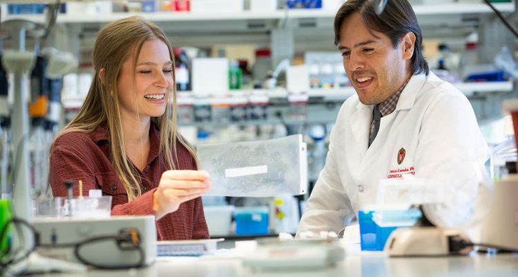 photo of Dr. Francisco Alvarado and member of lab team at the lab bench