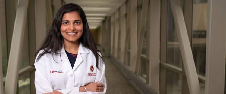 Shivani Garg, MD, MS, stands with her arms crossed, wearing her white coat.