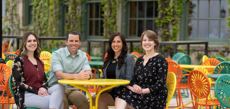 Incoming chief residents, Nadia Sweet, MD, John Davis, MD, Gabby Waclawik, MD, MPH, and Nadia Sweet, MD, sit on the colorful sunburst Terrace chairs