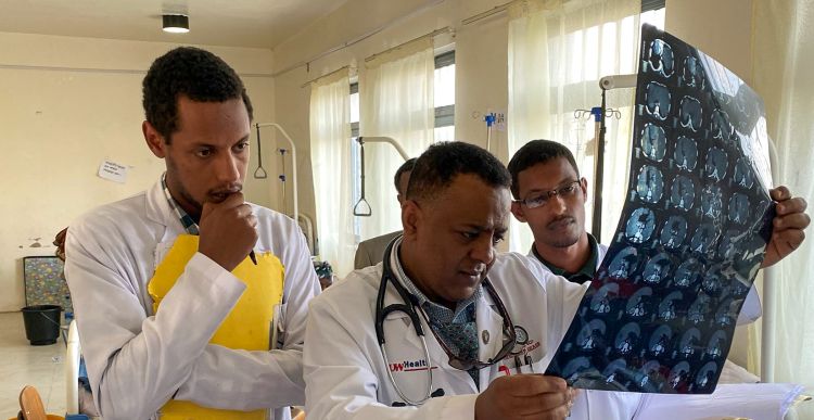 Dr. Siraj and global health colleagues reviewing an x-ray