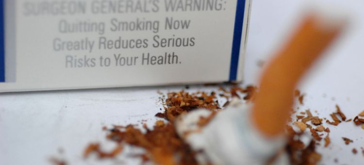 Photo of surgeon general&#039;s warning and putting out cigarette