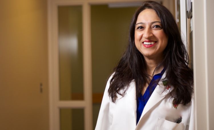 Dr. Nasia Safdar wearing a while lab coat