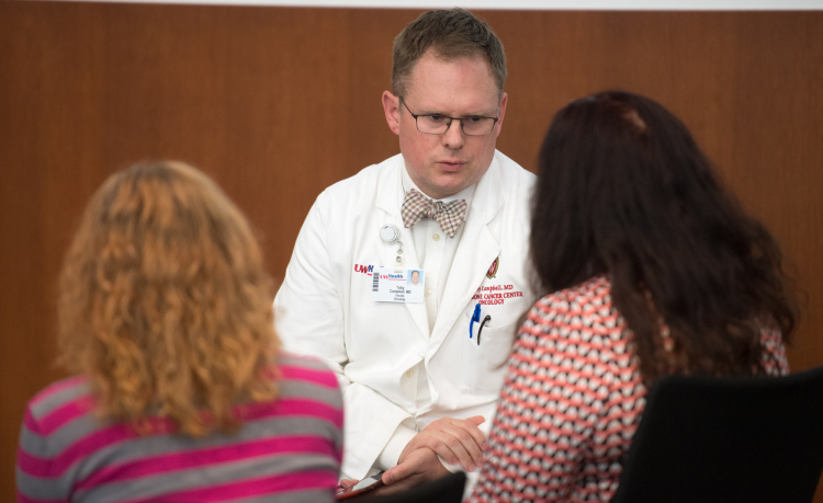 Toby Campbell, MD, discusses care with patients.