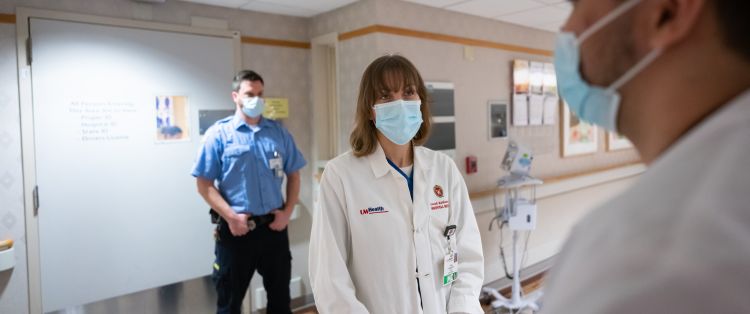Dr. Farah Kaiksow and learner with corrections officer in background
