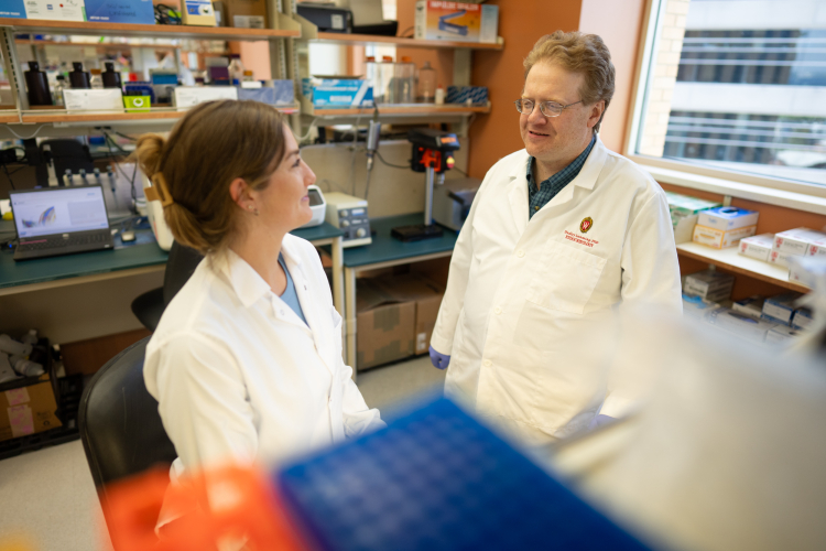 Research assistant and lead author, Michaela Trautman, in the lab with senior author Dudley Lamming, PhD.