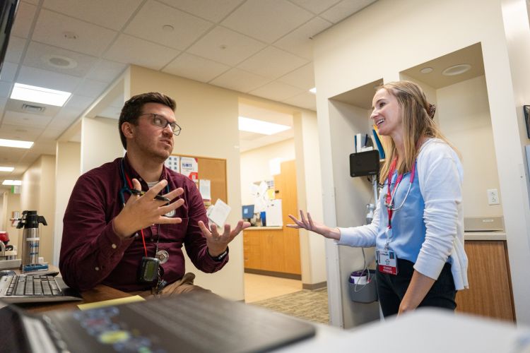 Dr. Michael Houghan talks with a resident.