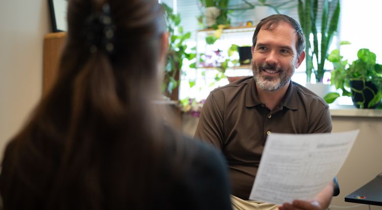 David Castellanos, PA, physician assistant-primary care, General Internal Medicine, consulting with a colleague on a recent ADHD evaluation. 