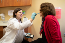 Dr Pulia performs a salivary test on a patient