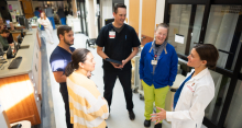 Dr. Kruser, far right, in communication with interdisciplinary ICU team members, which include (from right) Sherry McMullan, BSN, RN; Matt Willenborg, PharmD, BCPS; Wesley Hoppe, BSN, RN; and  Olivia Orencia, MSW, APSW. Credit: Clint Thayer/Department of Medicine.