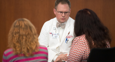 Toby Campbell, MD, discusses care with patients.