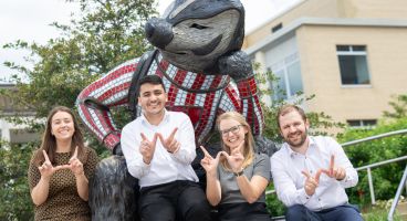 Haley Probst, Mazen Almasry, Geralyn Palmer, and Lucas Fass in front of a Bucky Badger statue
