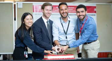 Four internal medicine residents shared in the ceremonial cutting of a cake in celebration of the 15th anniversary of Research Day. L-R: Jeanette Liou, MD, chief resident; Clayton Skogman, MD, PG-3; Bikrum Chahal, MD, PG-3; and Ahmed El Shaer, MBBS, chief resident.