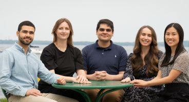 The 2025-26 chief residents sitting at a table outside.