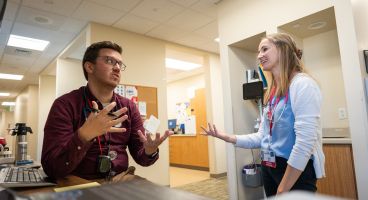 Dr. Michael Houghan talks with a resident.