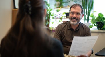 David Castellanos, PA, physician assistant-primary care, General Internal Medicine, consulting with a colleague on a recent ADHD evaluation. 