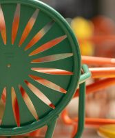 Green and orange chairs at a table