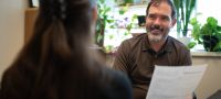 David Castellanos, PA, physician assistant-primary care, General Internal Medicine, consulting with a colleague on a recent ADHD evaluation. 