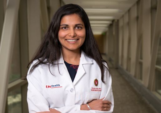 Shivani Garg, MD, MS, stands with her arms crossed, wearing her white coat.