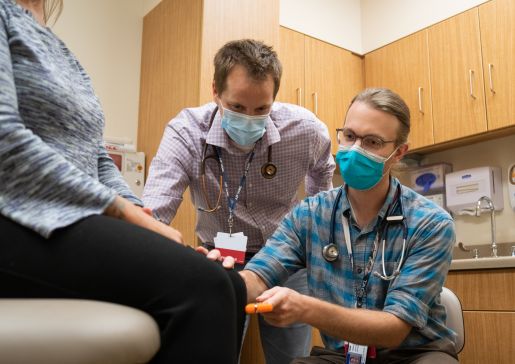 Residency director Andy Coyle, MD, works with Adam Strand, MD, in a clinic