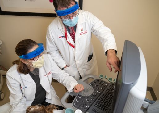 Matthew Tattersall, DO, MS, and Claudia Korcarz, DVM, look at arterial injury on an ultrasound