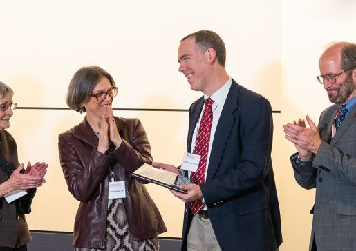 Dr. Loren Denlinger receives a plaque honoring his investiture as the inaugural William W. and Judith H. Busse Endowed Professor in Allergy and Asthma Research. From left: Dr. William Busse; Judith Busse; Dr. Elizabeth (Betsy) Trowbridge; Dr. Loren Denlinger; SMPH Dean Dr. Robert N. Golden; Dr. Nizar Jarjour.