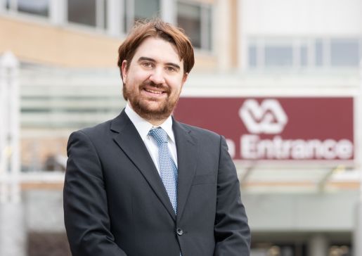 Dr. Aaron Kuntz stands in front of the VA