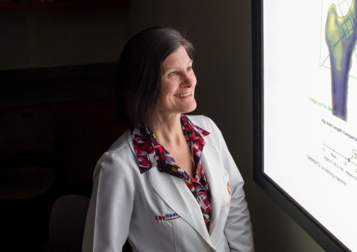 photo of Dr. Karen Hansen looking at bone density scan