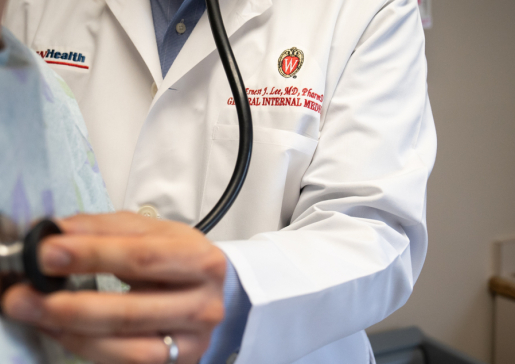 A doctor checks a patient's heartbeat.