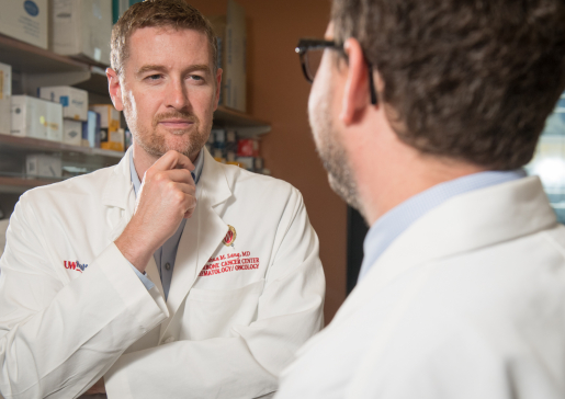 Dr. Josh Lang talks to Dr. David Kosoff in the lab